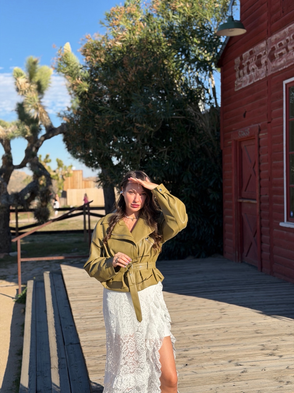 Antonina in an olive jacket and lace skirt